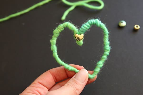 green heart with gold bead