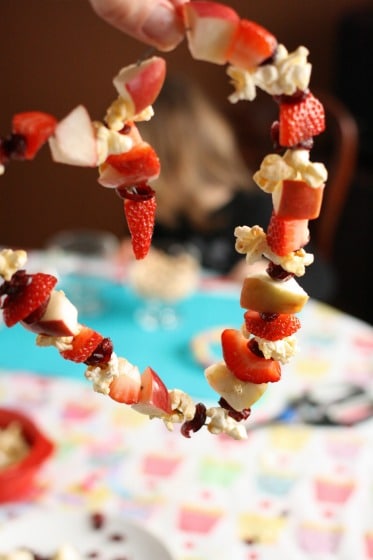 heart shaped bird feeder with fruit and popcorn