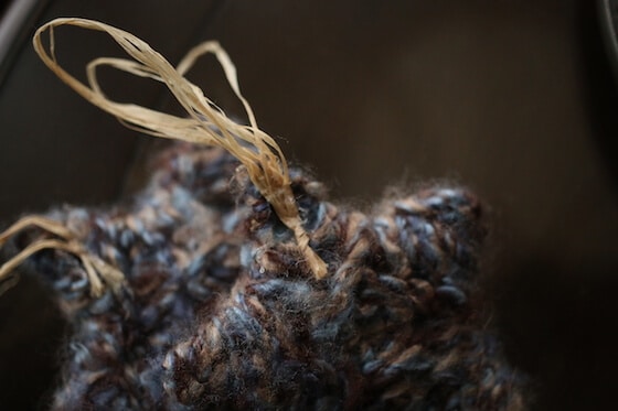 homemade star ornament with raffia and yarn