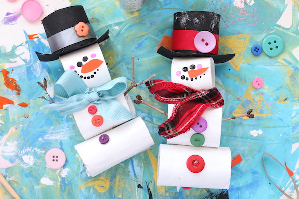 toilet paper roll snowmen on blue background