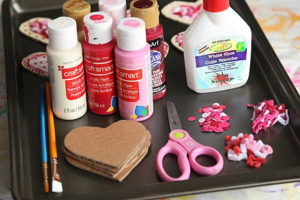 cardboard hearts, paint, glue, yarn sprinkles, pipe cleaner sprinkles, scissors