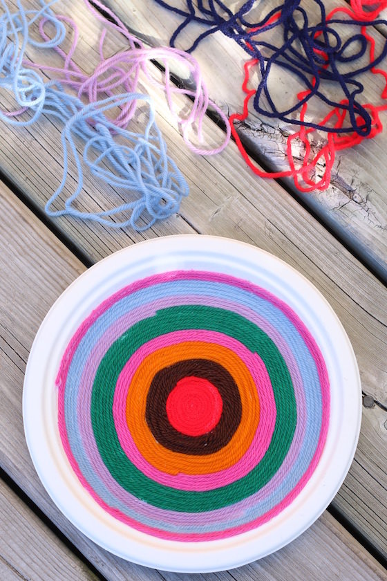 supplies for making yarn art on a paper plate