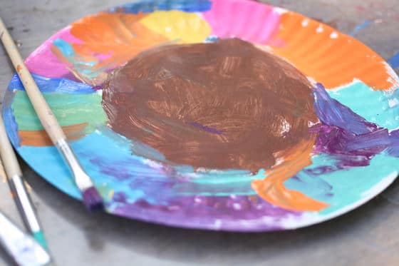 colourfully painted paper plate with brown center