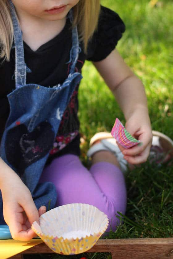 preschooler playing with cupcake liners