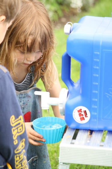 preschooler pouring water into bowl