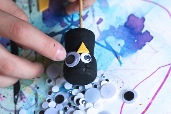 gluing googly eyes on cork craft