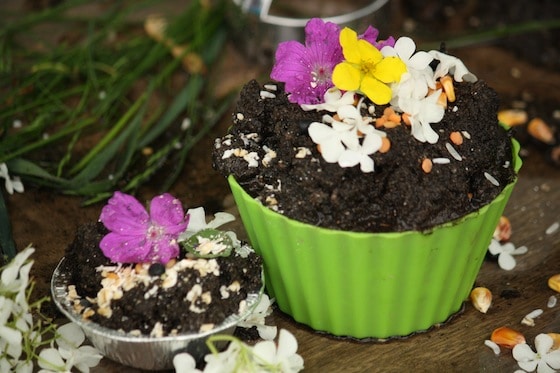 mud pie decorated with flowers, oatmeal and corn kernels