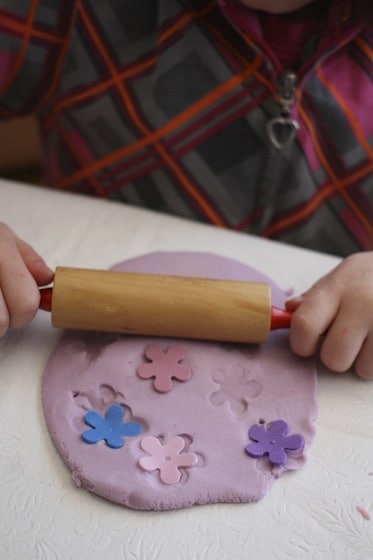 rolling foam flowers in playdough 