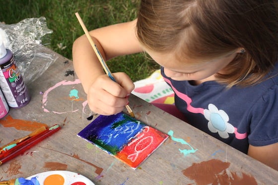 child making fridge magnet with crayon resist