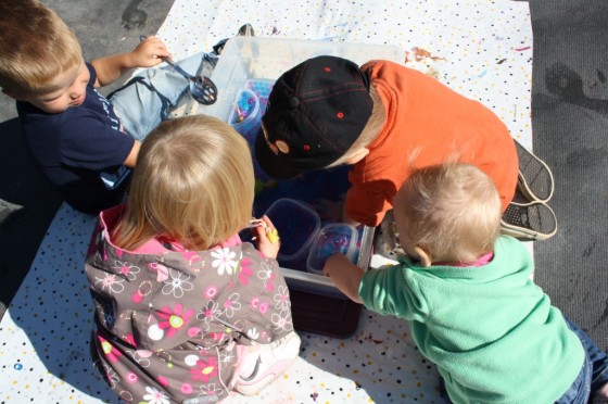 daycare kids gathered around water bead sensory bin