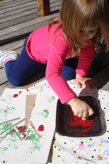 Child stamping with red paint