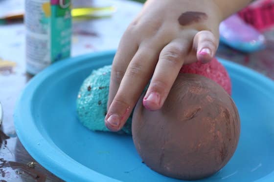 placing styrofoam ice cream on a paper plate