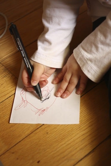 toddler drawing ladybugs before making their craft