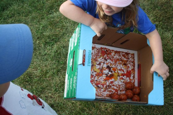 preschooler making fall art with paint and golf balls