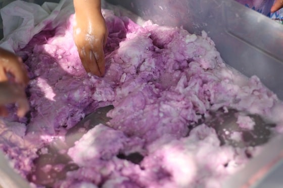 mixing toilet paper and coloured soapy water together to get fairy mud