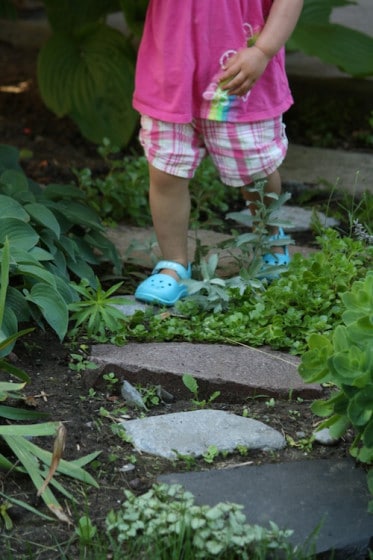 toddler walking and balancing on stepping stones