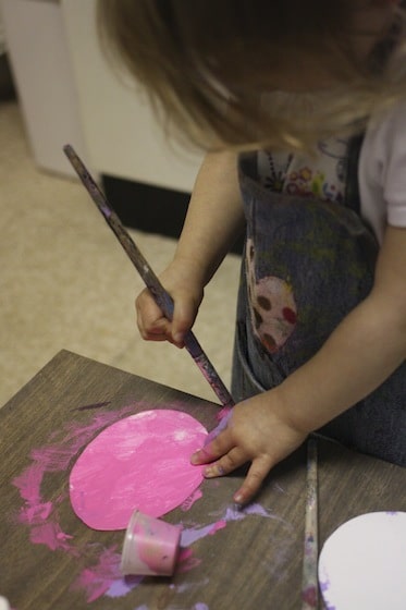 Toddler painting cardboard easter egg