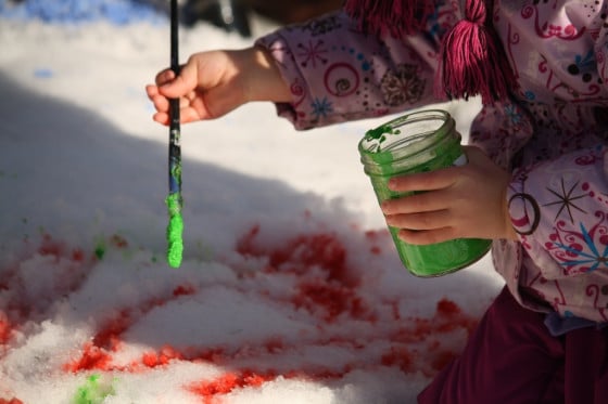 painting the snow with green and red paint