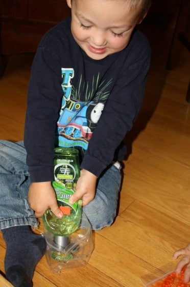 child filling sandwich bag with hair gel