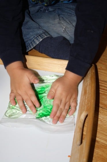 child squishing hair gel in sandwich bag