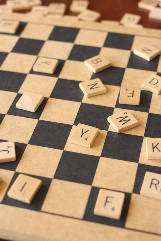 preschoolers playing with scrabble tiles on a checkerboard