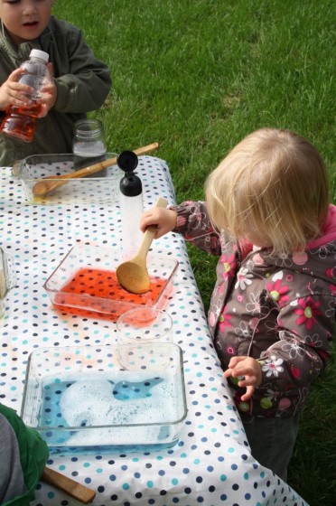 toddler stirring red water