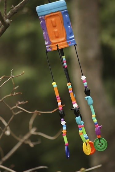 colourful plastic bottle wind chimes hanging in tree