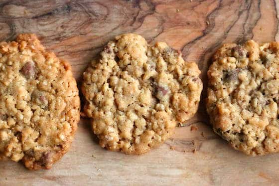 3 oatmeal, chocolate chip and crispy rice cookies on wooden cutting board