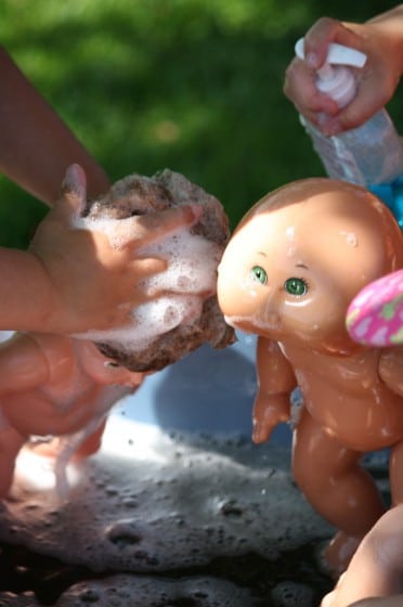 kids shampooing dolls hair