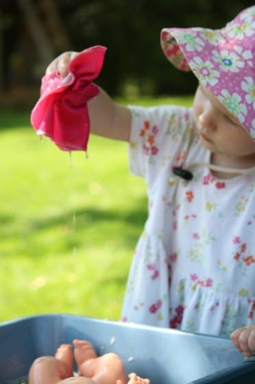 toddler holding doll washcloth