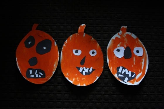 Painted jack o lanterns with face pieces cut out of paper