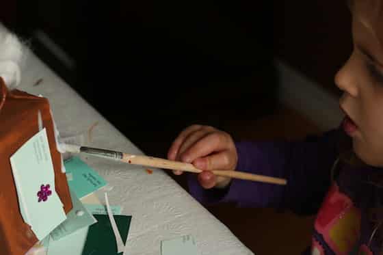 gluing decorations on preschool gingerbread craft