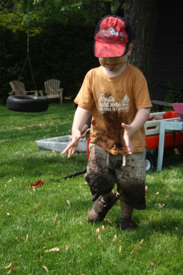 toddler with muddy shirt and shorts