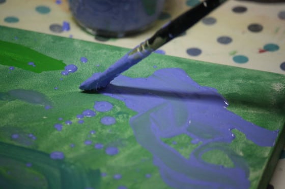 close up child's paintbrush with blue tempura paint