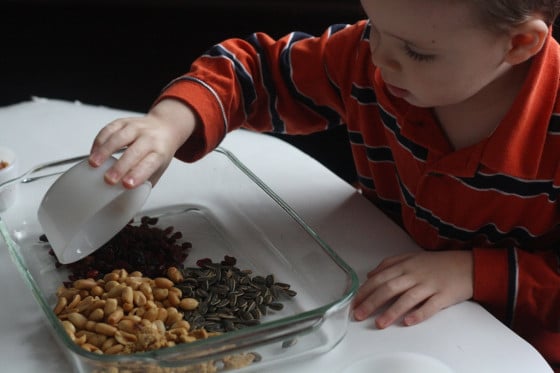 mixing the ingredients for homemade orange cup bird feeders