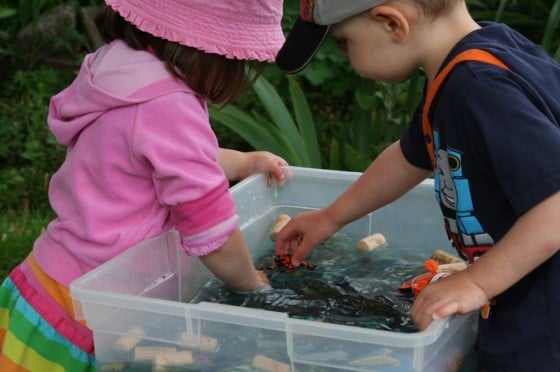 preschool girl and boy at ocean sensory bin