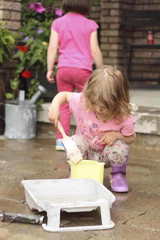 painting with water and a large paint brush