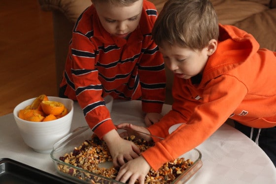 toddler and preschooler stirring the mix for our bird feeders