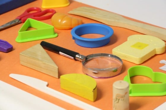 toys and kitchen items laid out on paper for a DIY matching game