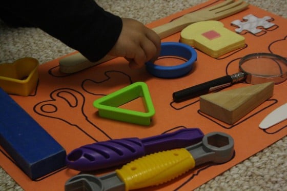 Child playing with homemade matching game.