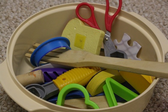 bowl full of toys and utensils for homemade matching game