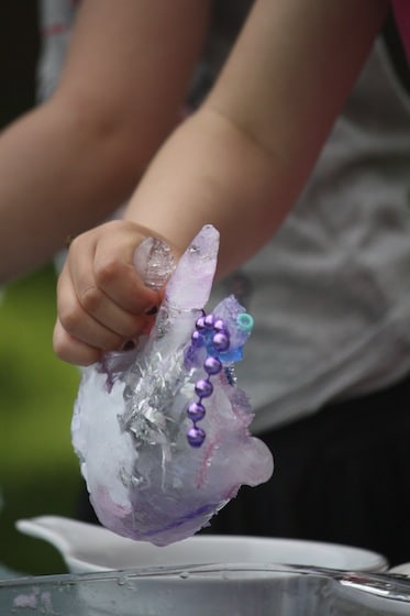 preschooler melting ice hand with salt and water