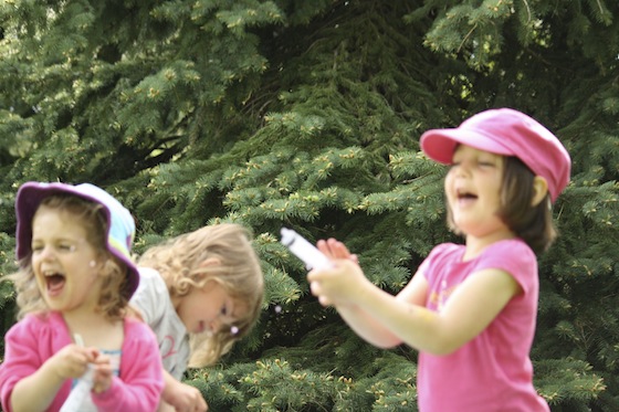 preschoolers squirting water with syringes