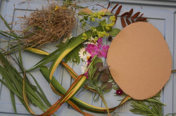 cardboard oval, long grasses, flowers