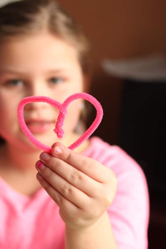 kid holding heart shaped pipe cleaner