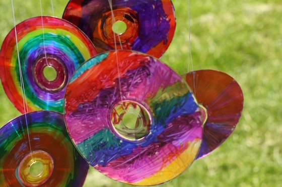 coloured CDS hanging from coffee can with fishing line