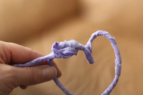 knotting fabric wrapped around pipe cleaner