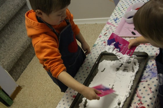 smoothing the shaving cream with an expired gift card