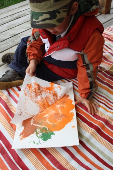 toddler creating pumpkin art