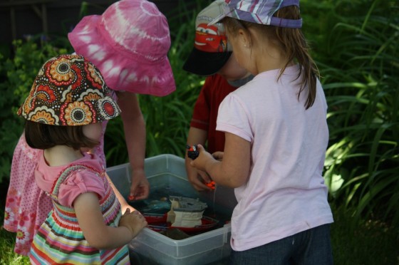 Toddler and preschooler playing outside